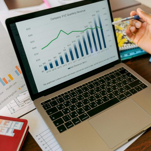 A close-up view of a laptop displaying business analytics and revenue charts.